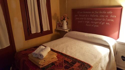 a small bedroom with a bed with towels on it at Carmen De Arnas in Colungo