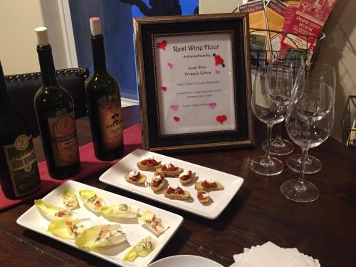 a table with two plates of food and wine glasses at Rest, a boutique hotel in Plymouth