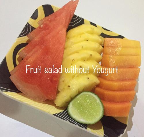 a plate of fruit saladwithout your stuff with a cucumber at Gubug Balian Beach Bungalow in Selemadeg