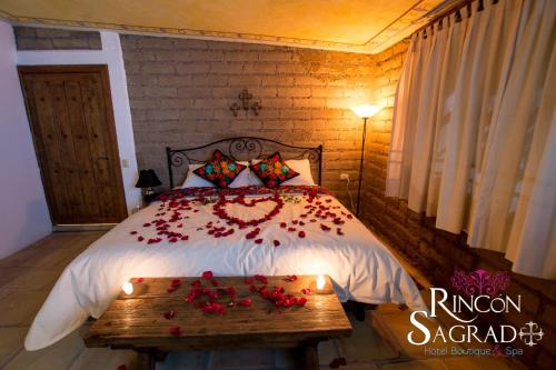 a bedroom with a bed with flowers on it at Hotel Boutique Rincon Sagrado in Atlixco