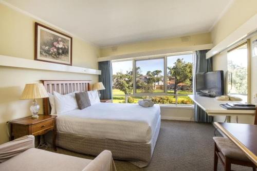 a hotel room with a bed and a tv at Aberdeen Motor Inn in Geelong