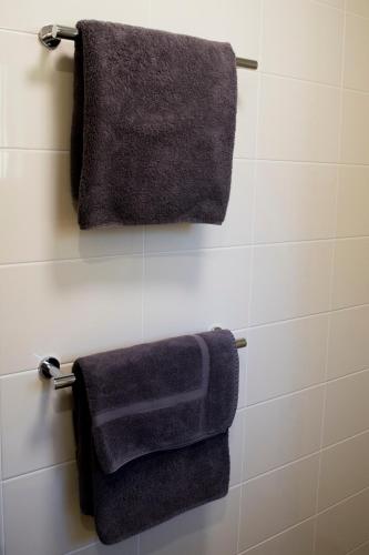 two towels hanging on a towel rack in a bathroom at Highway Inn Motel in Hay