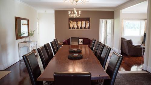 a dining room with a wooden table and chairs at Parkfarm Views in Albany