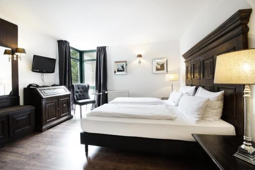 En eller flere senge i et værelse på Höhen Hotel Viersen