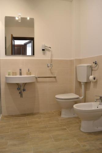 a bathroom with a toilet and a sink and a mirror at Domus Duomo in Florence
