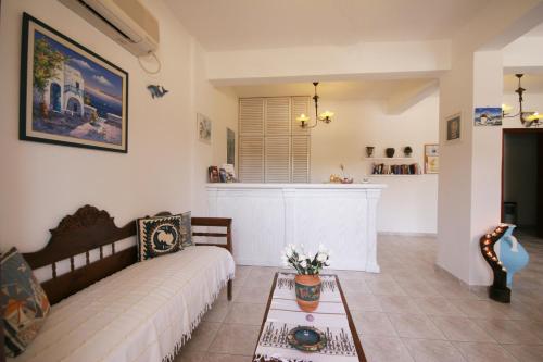 a living room with a bed and a table at Horizon Resort in Kamari