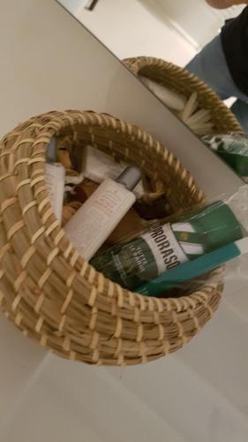 a basket with a toothbrush and a tooth paste at B&B Vistamare Suite in Agropoli
