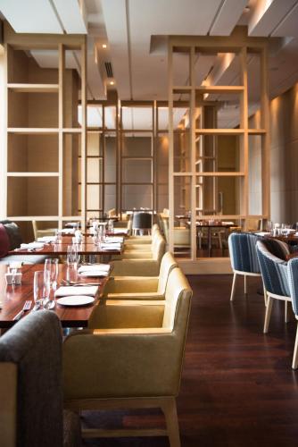 a dining room with a long table and chairs at Hyatt Regency Lucknow Gomti Nagar in Lucknow