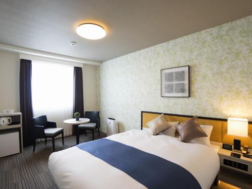 Кровать или кровати в номере Hotel La'gent Plaza Hakodate Hokuto