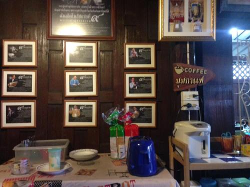 a table in a restaurant with pictures on the wall at Boobpha Resort in Amphawa