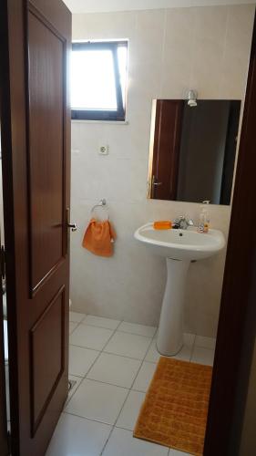 a bathroom with a sink and a mirror at Jardins Piornais Funchal Apartment in Funchal