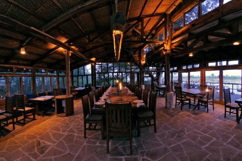 un comedor con una mesa larga en un edificio en Ken River Lodge en Rājgarh