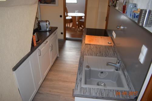 a kitchen with a sink and a counter top at Messewohnung Gräfrath in Solingen