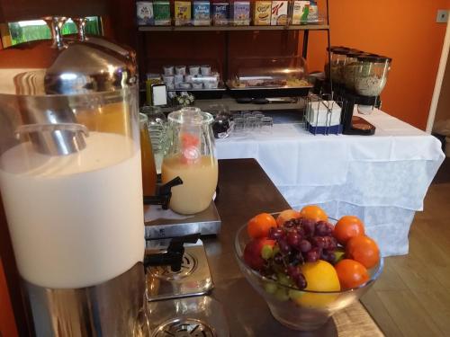 a jug of milk and a bowl of fruit on a counter at Waterfront Hotel in Deal