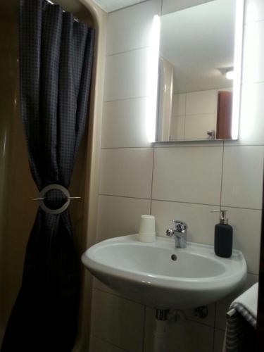 a bathroom with a sink and a mirror at Ferienhaus Zum Amthof in Alsfeld