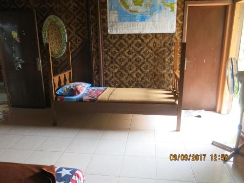 a bed in the corner of a room at Salak Sunrise Homestead in Bogor