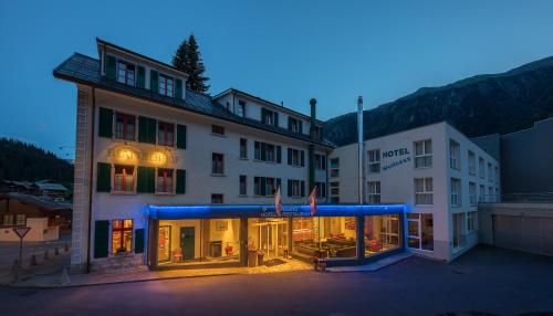 a large building with a blue lit up facade at Hotel Blattnerhof in Blatten bei Naters