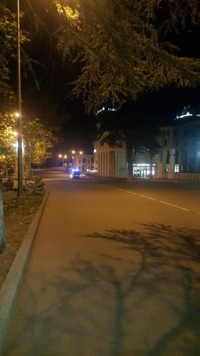 an empty street at night with lights on at Apartment on Kolkheti Street 1 in Tskaltubo