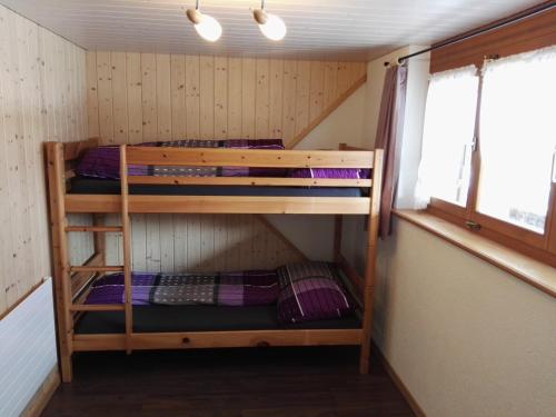 a bunk room with two bunk beds in it at FEWO Rophaienblick in Isenthal