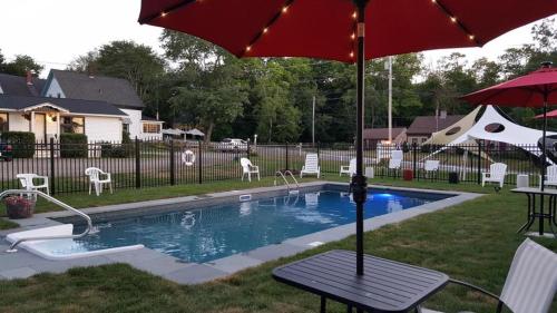 a picnic table with an umbrella next to a pool at Starlight Lodge at Rockport Harbor in Rockport