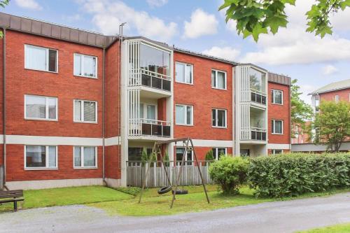 an apartment building with a playground in front of it at A lovely one-room apartment near the city centre. in Vaasa