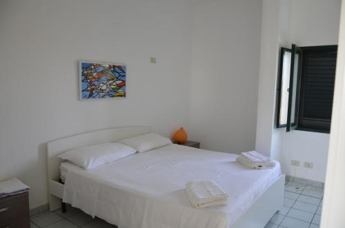 Guest House Punta Fram tesisinde bir odada yatak veya yataklar