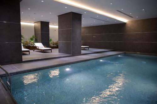a large swimming pool in a hotel room at Executives Hotel - KAFD in Riyadh