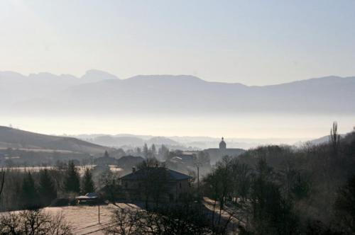 a view of a town with mountains in the background at Gîte La Grange Du Haut in Saint-Antoine