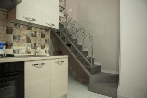 une cuisine avec un escalier en colimaçon et un évier dans l'établissement Casa Toto', à Naples