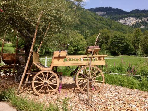 a wooden horse drawn carriage sitting on top of gravel at Eichhof Brienzwiler Berner Oberland in Brienzwiler