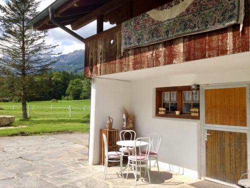 a patio with a table and chairs in front of a building at Eichhof Brienzwiler Berner Oberland in Brienzwiler