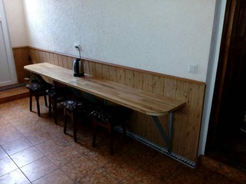 a wooden table in a room with chairs around it at Hostel Mnogoborets F. Klub in Odesa