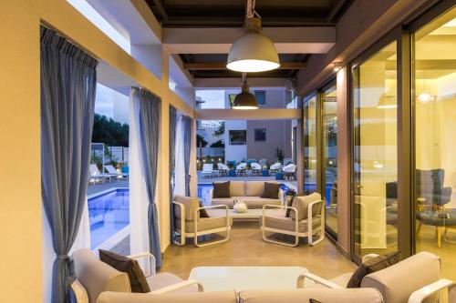 a living room with couches and a pool at Menta City Boutique Hotel in Rethymno Town