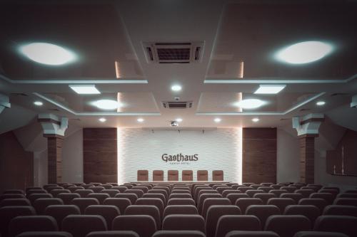 an empty auditorium with a screen with the words catechins on it at GasthauS & SPA in Bukovel