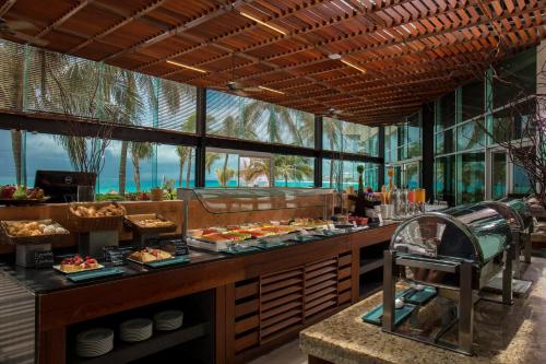 a restaurant with a buffet with food on display at Altitude at Krystal Grand Cancun - All Inclusive in Cancún