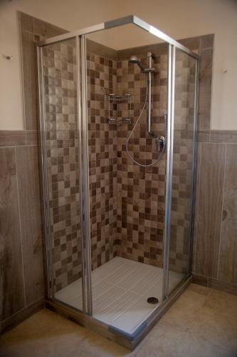 a shower with a glass enclosure in a bathroom at 3 Archi B&B in Trani