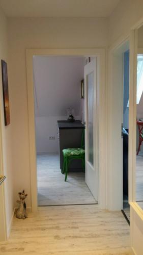 a view of a hallway with a green stool in a room at Mach mal Pause bei Geni & Bernd in Kleineichen
