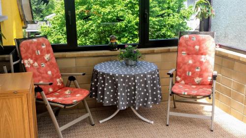 a table with two chairs and a table with a table cloth at Mach mal Pause bei Geni & Bernd in Kleineichen