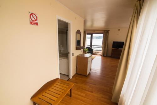 a room with a bench and a room with a door at Hotel Terrazas del Lago in Puerto Varas