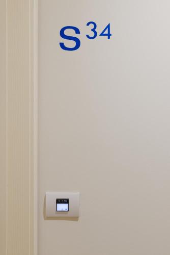 a door with a clock on the side of it at Hotel Mediterraneo in Sottomarina