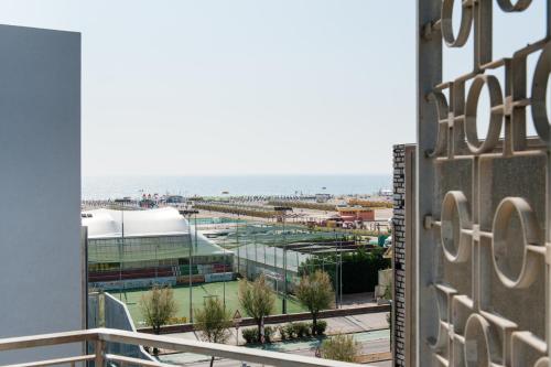 a view from the balcony of a building with a tennis court at Hotel Mediterraneo in Sottomarina