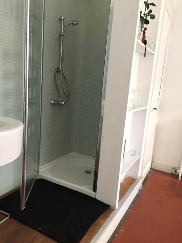 a shower with a glass door in a bathroom at Liberté in Marseille