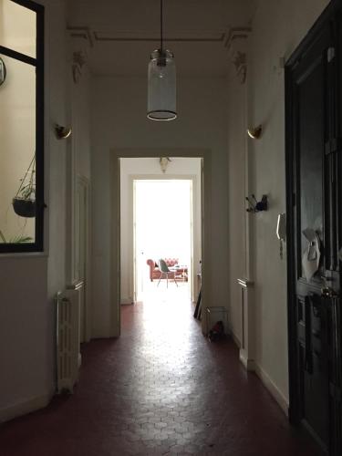an empty hallway with a door leading into a room at Liberté in Marseille