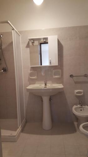 a bathroom with a sink and a shower and a toilet at Borgo Saraceno in Sambuca di Sicilia