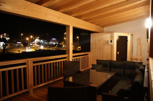 a living room with a couch and a table on a balcony at Ferienhaus Zangerl in Oetz