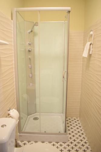 a shower with a glass door in a bathroom at Casa Rural Herrera in Villacarrillo