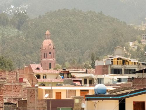 a view of a city with a clock tower at Hostal La Rosa Otavalo in Otavalo