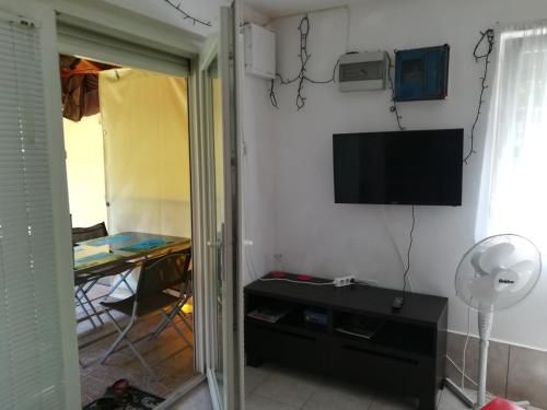 a room with a flat screen tv on a wall at Tiszavirág Vendégház in Szeged