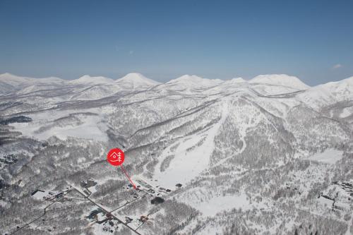 a stop sign on top of a snow covered mountain at Niseko Backcountry Lodge in Niseko