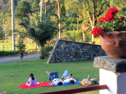 a group of figurines laying on a blanket in the grass at Reserva Guadalajara - Cocora Valley in Salento